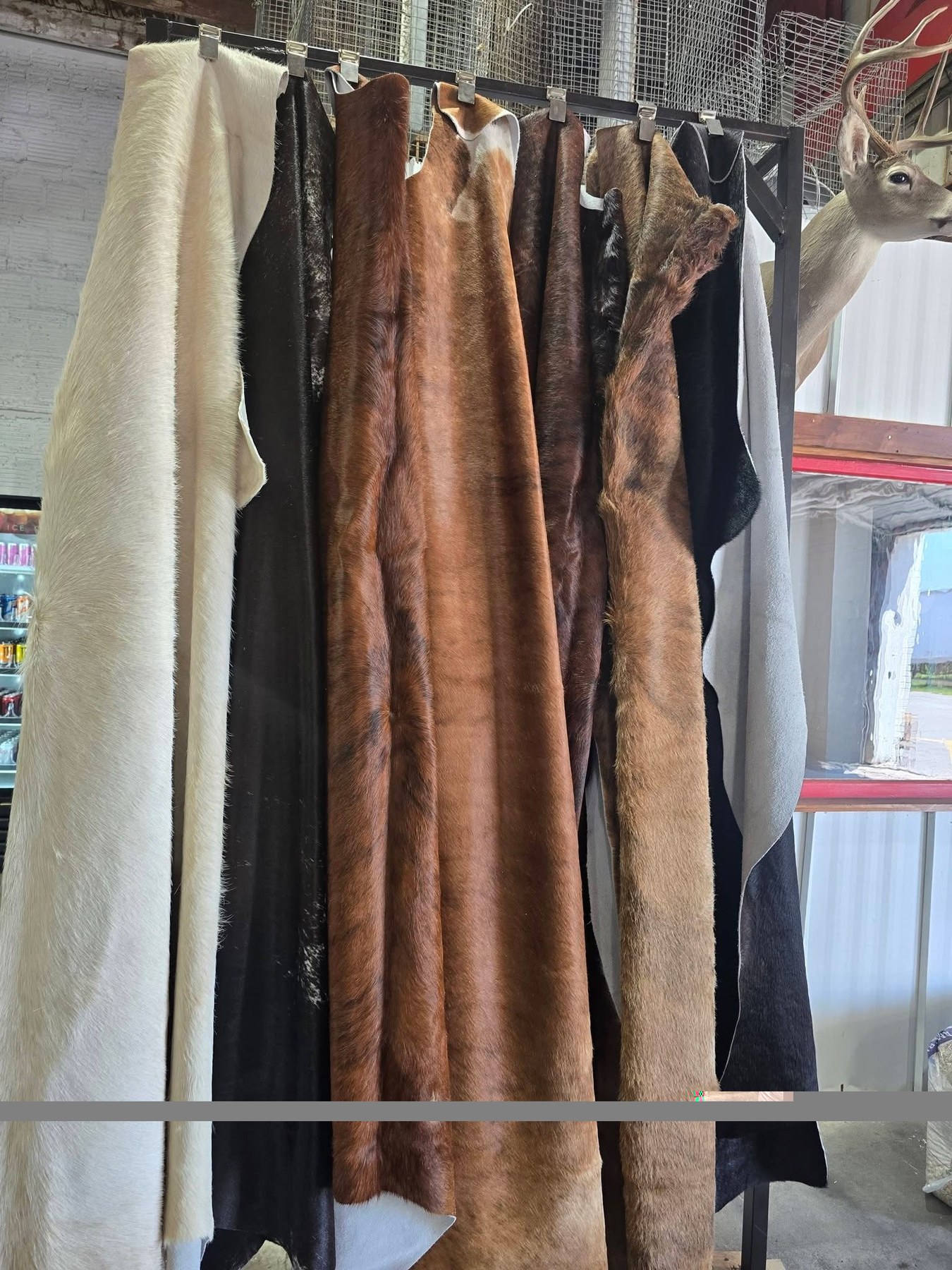 Cowhides hanging by the shop door